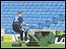 Groundsman mowing pitch