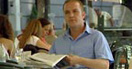A mystery man sitting at a café table