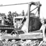Gene Fiducia operating D7 angle dozer somewhere in Normandy June 1944. Demolishing stone house for gravel to construct and repair bombed roads. Gene Fiducia operating D7 angle dozer somewhere in Normandy June 1944. Demolishing stone house for gravel to construct and repair bombed roads.