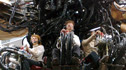 Puppeteers underneath the body of the spider