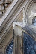 Weathered stonework around stained glass window