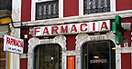 A shop front with the sign 'Farmacia'