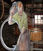A model of a man making a barrel.