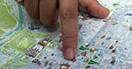 Finger pointing on map of central Madrid