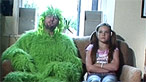 Maggot and a young girl sitting on a sofa in a living room