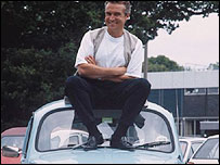 bloke sat on a car