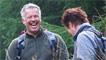 Derek laughs as he gets his boot stuck in the mud